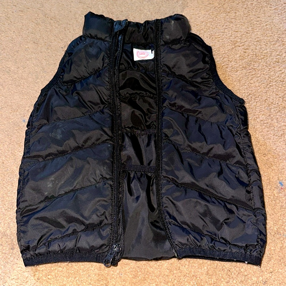 A black vest, has inside pockets.